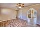Open-concept living room with new hardwood flooring and an archway to the kitchen at 11 Grove Ln, Hampton, GA 30228