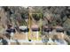 Aerial view of the property plot outlined in yellow among surrounding homes in the neighborhood at 11 Grove Ln, Hampton, GA 30228