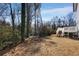 A treed backyard with stairs leading to a wooden deck at 2150 Essex Sw Ave, Atlanta, GA 30311