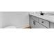 Contemporary half bathroom with white marble countertops, vanity, and hardwood floors at 2150 Essex Sw Ave, Atlanta, GA 30311