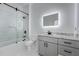 Modern bathroom featuring marble floors, lighted mirror, and shower with black hardware at 2150 Essex Sw Ave, Atlanta, GA 30311