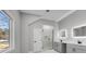 Modern bathroom with gray vanity, dual sinks, lighted mirrors, and a glass-enclosed walk-in shower at 2150 Essex Sw Ave, Atlanta, GA 30311