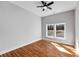 This bedroom has beautiful hardwood floors, a ceiling fan, and a large window that brings in tons of natural light at 2150 Essex Sw Ave, Atlanta, GA 30311