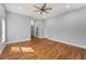 Bedroom with wood floors, gray walls, a ceiling fan, and multiple entryways at 2150 Essex Sw Ave, Atlanta, GA 30311