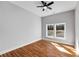 Bright bedroom with wood floors, light gray walls, ceiling fan, and a double window with outside views at 2150 Essex Sw Ave, Atlanta, GA 30311