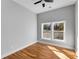 Bright bedroom with wood floors, light gray walls, ceiling fan, and a double window with outside views at 2150 Essex Sw Ave, Atlanta, GA 30311
