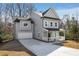 Stylish two-story home with a long driveway, attached garage, and inviting front porch at 2150 Essex Sw Ave, Atlanta, GA 30311