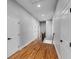 Hallway with hardwood floors leads to stairs with metal and wood railings at 2150 Essex Sw Ave, Atlanta, GA 30311