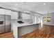 Bright kitchen featuring stainless steel appliances, a spacious island, and hardwood floors throughout at 2150 Essex Sw Ave, Atlanta, GA 30311