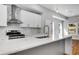 Modern kitchen with white cabinets, stainless steel appliances, and large island with marble countertops at 2150 Essex Sw Ave, Atlanta, GA 30311