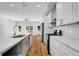 Modern kitchen with a large island, quartz countertops, stainless steel appliances and white cabinets at 2150 Essex Sw Ave, Atlanta, GA 30311