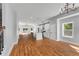 Open-concept living space with hardwood floors connecting kitchen, living and dining areas at 2150 Essex Sw Ave, Atlanta, GA 30311