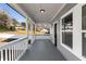 A covered front porch with white railings and ample space for outdoor seating and decor at 2150 Essex Sw Ave, Atlanta, GA 30311