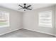 This bedroom has two windows with mini blinds, hardwood floors, and a ceiling fan at 2945 Catalina Dr, Decatur, GA 30032