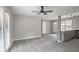 Inviting living area with light grey flooring, a ceiling fan, large windows and open layout at 2945 Catalina Dr, Decatur, GA 30032