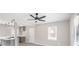 Living area featuring a ceiling fan, large windows, and an open kitchen at 2945 Catalina Dr, Decatur, GA 30032