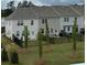 Backyard of new townhomes featuring lawn, fences, young trees, and landscaping at 3340 Cranston Ln, Kennesaw, GA 30144