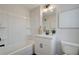 Bright bathroom features single vanity, tub with shower and a decorative mirror at 3340 Cranston Ln, Kennesaw, GA 30144