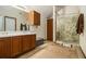 Bathroom featuring dual sinks with a large shower with glass enclosure at 5803 Star Flower Dr, Ellenwood, GA 30294