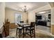 Inviting dining area featuring stylish light fixture and seamless flow into the adjacent kitchen space at 5803 Star Flower Dr, Ellenwood, GA 30294