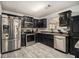 Modern kitchen with black cabinets, stainless appliances, and tile backsplash at 5803 Star Flower Dr, Ellenwood, GA 30294