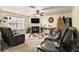 Comfortable living room featuring a fireplace, plush seating, and natural light from the window at 5803 Star Flower Dr, Ellenwood, GA 30294