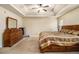 Spacious main bedroom with a tray ceiling, carpeted flooring, and traditional-style furniture at 5803 Star Flower Dr, Ellenwood, GA 30294