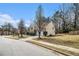 Neighborhood street view of home with landscaped yard and driveway on a sunny day at 5803 Star Flower Dr, Ellenwood, GA 30294
