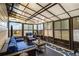 Relaxing sunroom filled with natural light with comfortable seating and unique ceiling at 5803 Star Flower Dr, Ellenwood, GA 30294