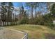Large grassy backyard enclosed by a chain-link fence and a shed at 1054 Shepherds Ne Ln, Atlanta, GA 30324