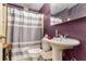 Dated bathroom with a pedestal sink, toilet, and shower with gray and white striped curtain at 1054 Shepherds Ne Ln, Atlanta, GA 30324