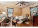 Untidy bedroom with hardwood floors, floral curtains, and a ceiling fan at 1054 Shepherds Ne Ln, Atlanta, GA 30324