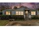 Charming single-story home with blue siding and landscaped front yard and an inviting front porch at 1054 Shepherds Ne Ln, Atlanta, GA 30324