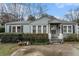 Charming single-story home with blue siding and landscaped front yard and an inviting front porch at 1054 Shepherds Ne Ln, Atlanta, GA 30324