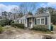 Charming single-story home with blue siding and landscaped front yard and an inviting front porch at 1054 Shepherds Ne Ln, Atlanta, GA 30324