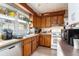 Functional kitchen with wood cabinets, standard appliances, and a double basin sink at 1054 Shepherds Ne Ln, Atlanta, GA 30324