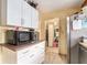 Modest kitchen featuring a microwave, white cabinets, and essential appliances at 1054 Shepherds Ne Ln, Atlanta, GA 30324