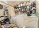 Cluttered laundry area with a washing machine, dryer, and ample shelving for storage at 1054 Shepherds Ne Ln, Atlanta, GA 30324