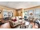Inviting living room featuring a comfortable sofa and hardwood floors adjacent to dining area at 1054 Shepherds Ne Ln, Atlanta, GA 30324