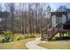 View of a wooden deck and landscaped backyard with mature trees at 1300 Village Oaks Ln, Lawrenceville, GA 30043