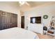 Bright bedroom featuring a ceiling fan, carpet, and a wall-mounted television above a white dresser at 1300 Village Oaks Ln, Lawrenceville, GA 30043