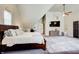 Well lit bedroom featuring a ceiling fan and ample space, with a king-sized bed at 1300 Village Oaks Ln, Lawrenceville, GA 30043