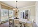 Bright dining room featuring a modern chandelier and views of the entrance hall at 1300 Village Oaks Ln, Lawrenceville, GA 30043