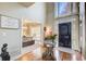 Inviting foyer with high ceilings, decorative glass door and an ornate glass entry table at 1300 Village Oaks Ln, Lawrenceville, GA 30043