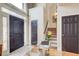 Bright foyer with a glass table, staircase, and a black front door with sidelights at 1300 Village Oaks Ln, Lawrenceville, GA 30043