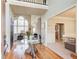 Spacious foyer featuring wood floors, an elegant glass table, and views of the living room at 1300 Village Oaks Ln, Lawrenceville, GA 30043