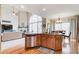 Open kitchen featuring granite countertops and seamlessly flowing into the living and dining areas at 1300 Village Oaks Ln, Lawrenceville, GA 30043