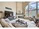 Cozy living room with a fireplace, large windows, and comfortable seating at 1300 Village Oaks Ln, Lawrenceville, GA 30043