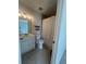 Well-lit bathroom featuring a single sink vanity, toilet, and shower with a white curtain at 1063 Riverbend Club Se Dr, Atlanta, GA 30339