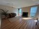 Spacious living room featuring hardwood floors, a fireplace, and natural light at 1063 Riverbend Club Se Dr, Atlanta, GA 30339